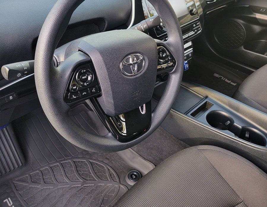 The inside of a toyota prius with a steering wheel