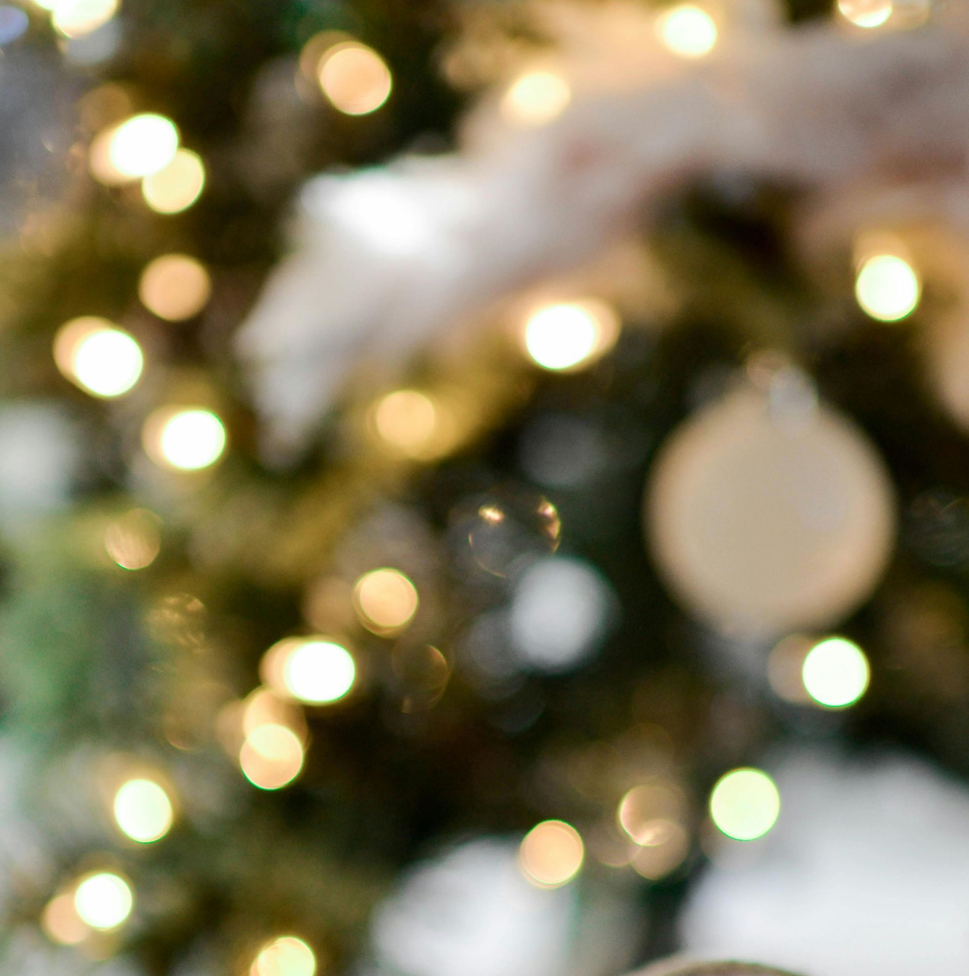 A close up of a christmas tree with lights and ornaments