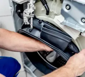 Hands installing a black speaker in a car door interior