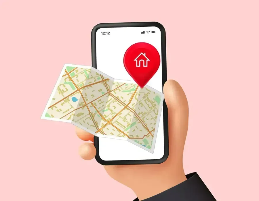 Hand holding smartphone with a map and red location pin on pink background