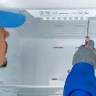 White Refrigerator in A Kitchen with A Brown Note
