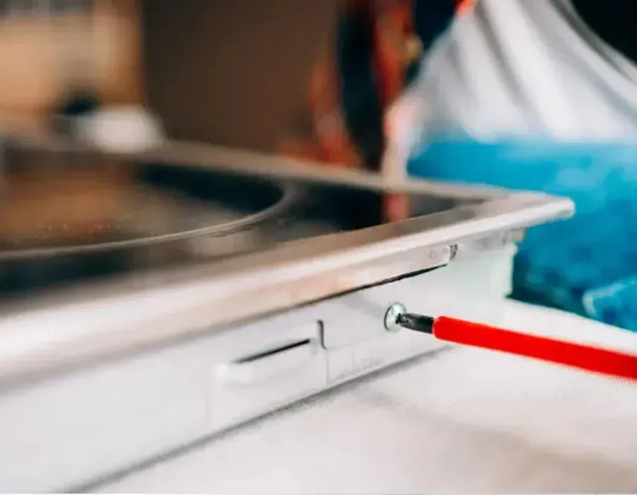 Red pencil plugged into a laptop USB port beside a blue fabric surface
