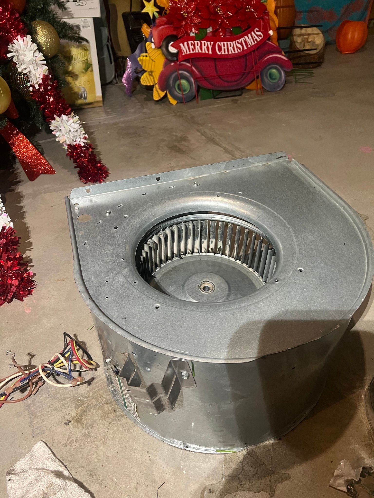 Comfy Castle Heating and Air - A toilet seat is sitting on the floor next to a christmas tree.