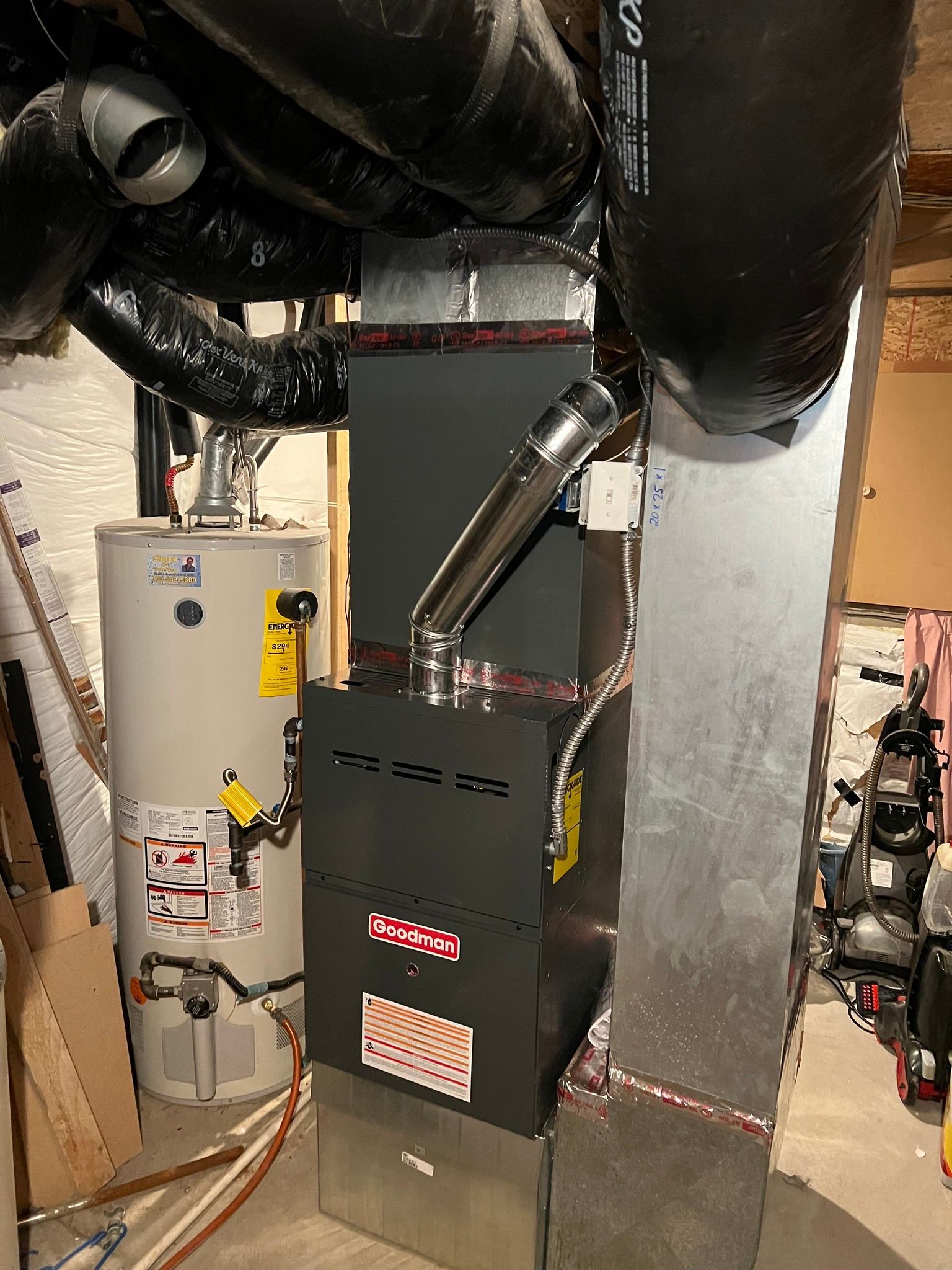 Comfy Castle Heating and Air - A heating and cooling system is installed in a basement next to a water heater.