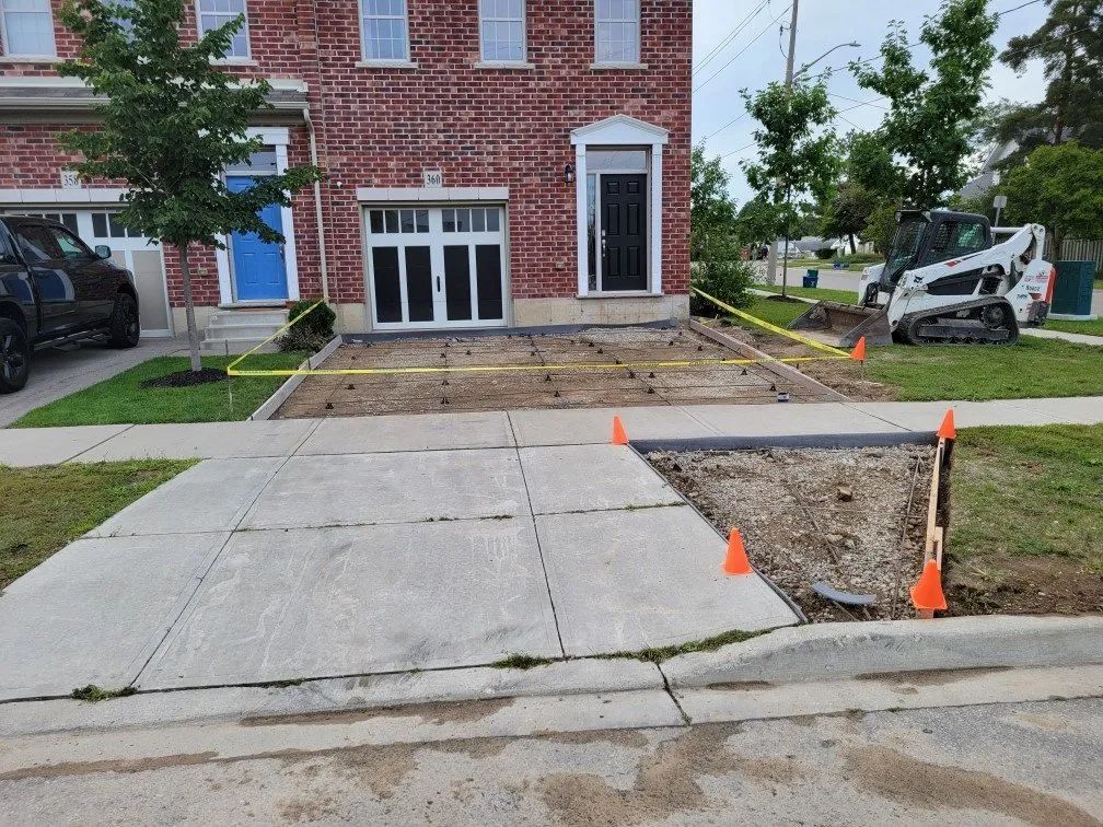 Front yard excavation and site prep underway for a new concrete driveway installation