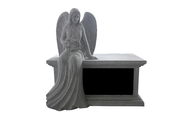 Gray angel statue seated on a rectangular tomb or pedestal
