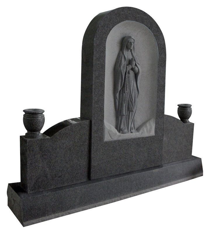 Black granite gravestone with a carved religious figure and two small urns on top