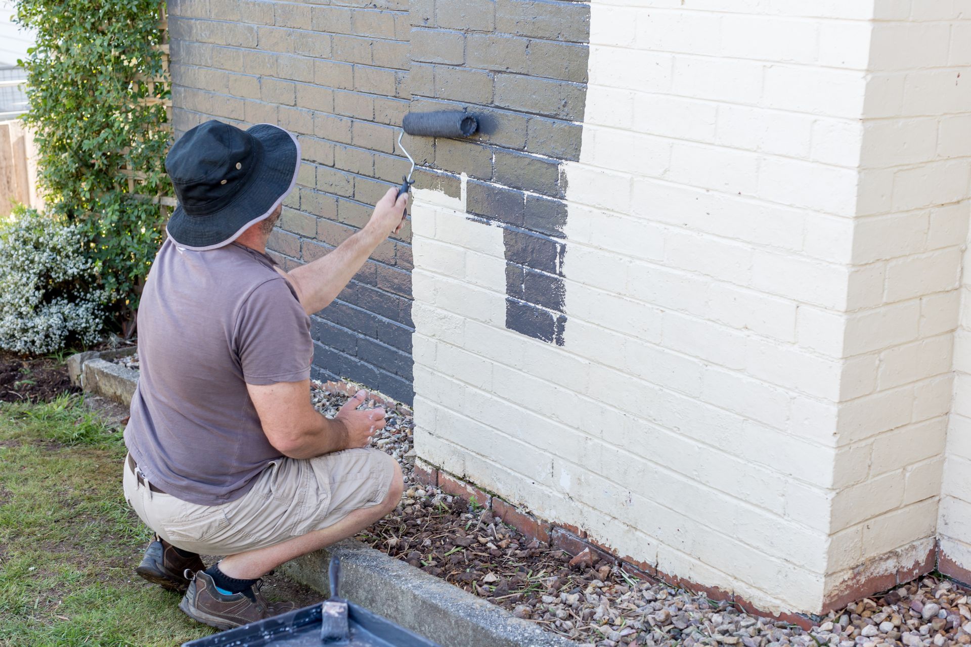 Pioneer Painters painting a brick wall grey