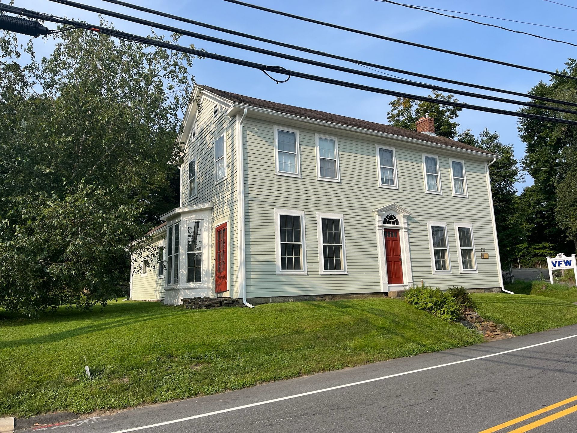 Exterior painting of a two-story home by Pioneer Painters in Enfield, CT