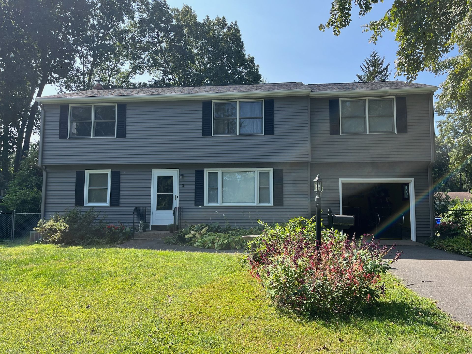Home exterior walls being painted by Pioneer Painters in Southwick, MA