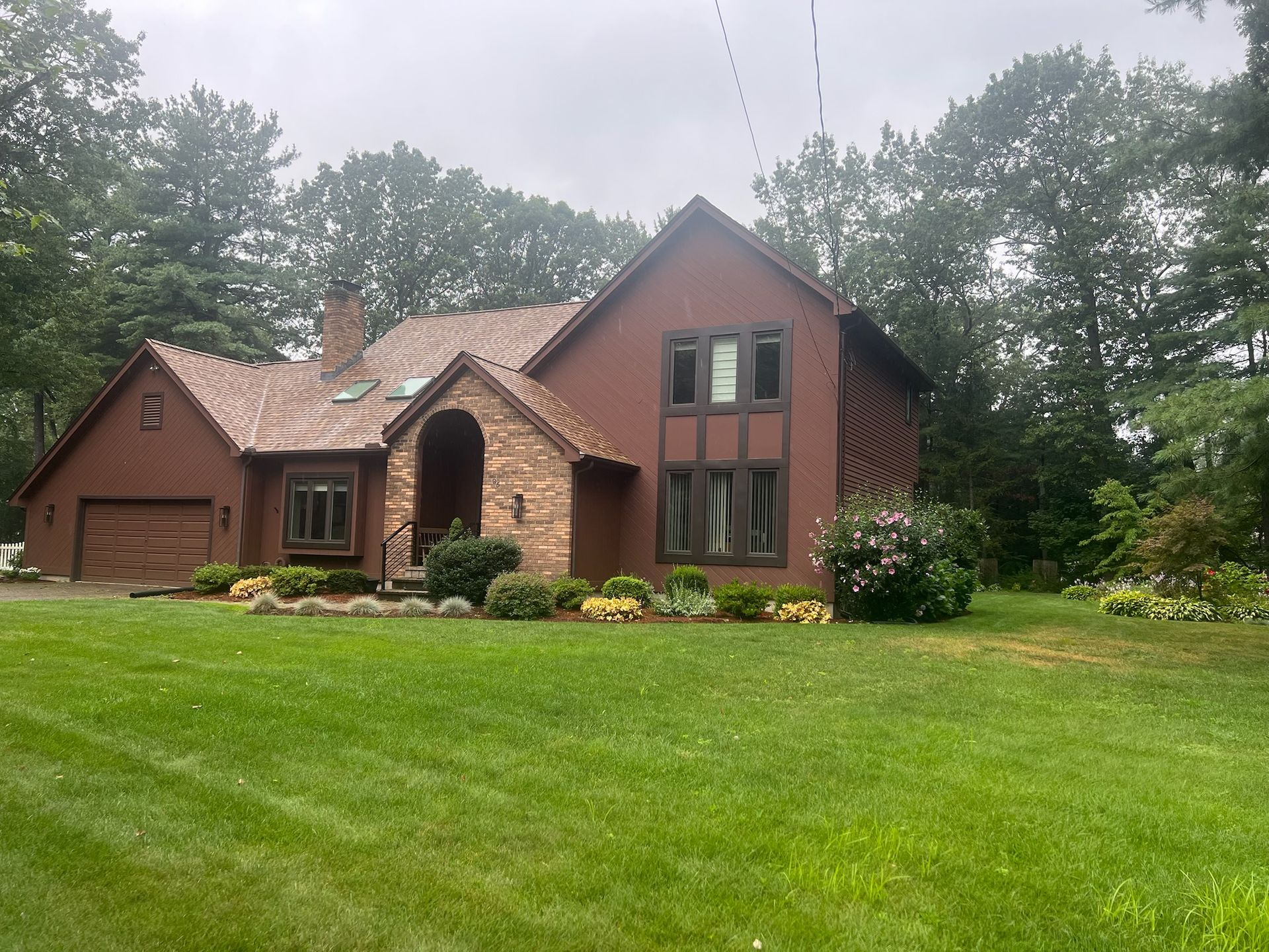 Home exterior getting a fresh coat by Pioneer Painters in Longmeadow, MA