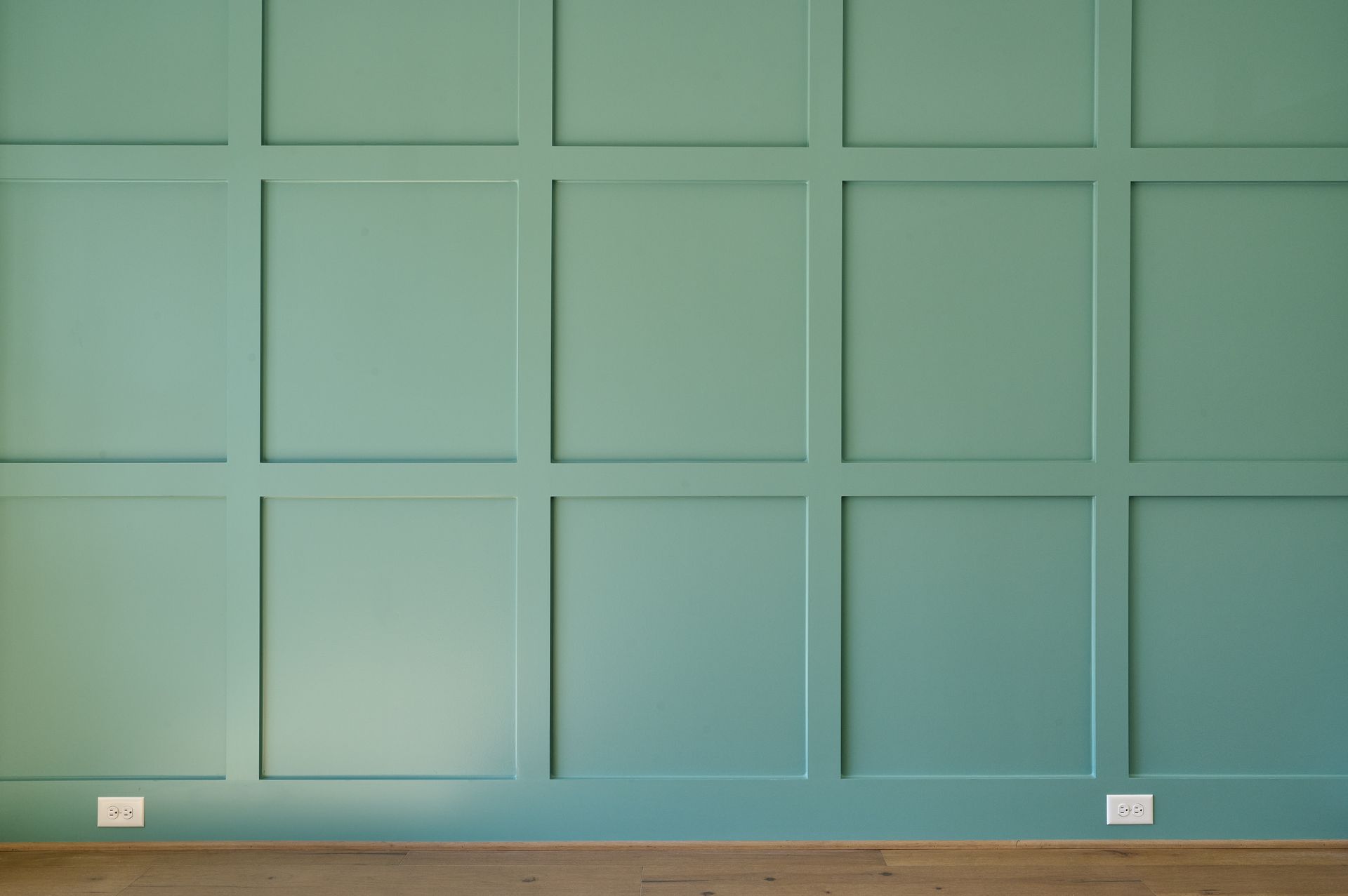 a green wall with squares on it