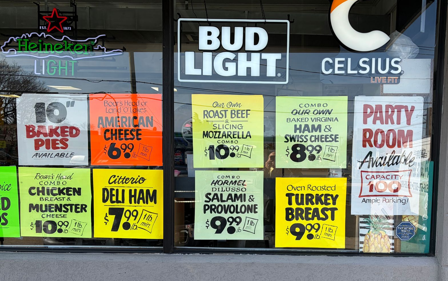 Cold Cut specials on colorful signs through the window