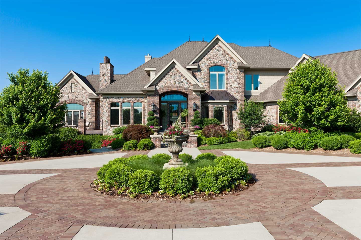 A large house with a fountain in front of it