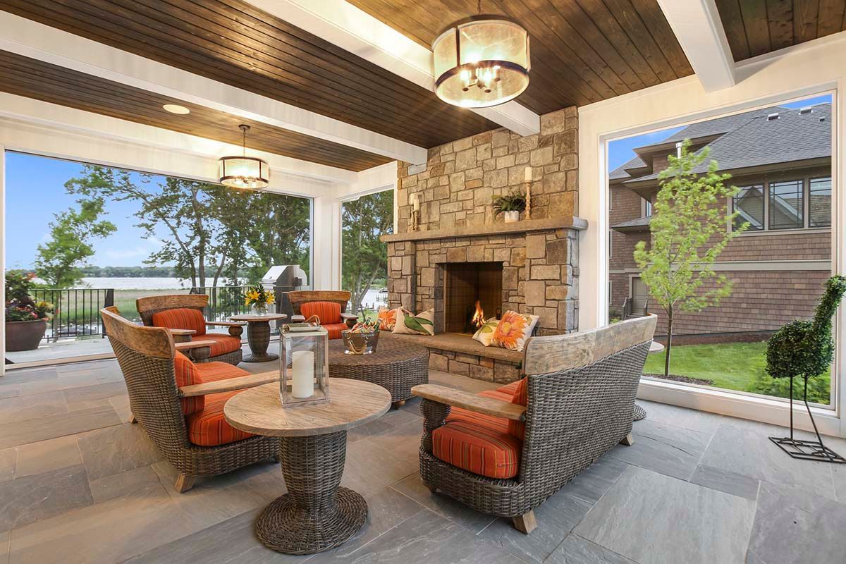 An outdoor patio with wicker furniture and an outfoor fireplace