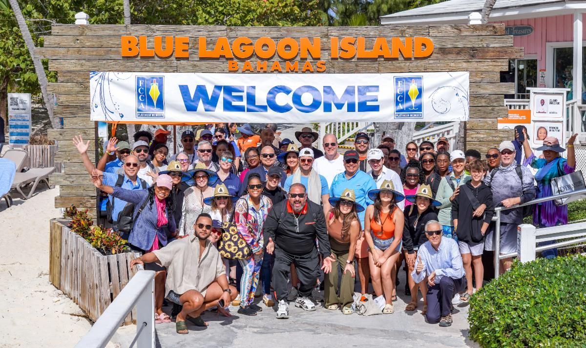Large group of people posing in front of a 