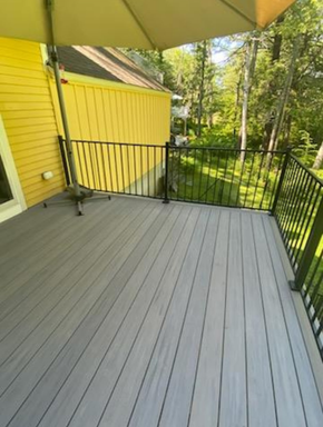 A gray house with a porch and a garage