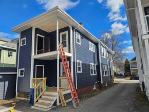 A house with a lot of siding on it is being built.