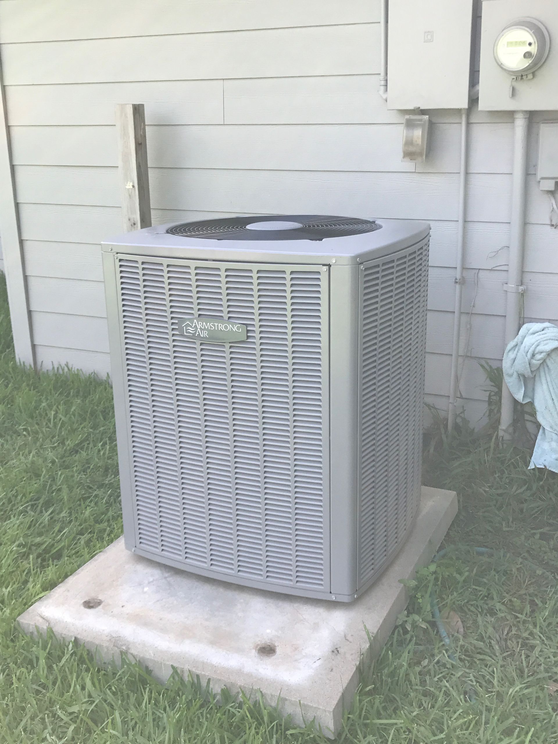 HVAC system interior: electric motor with belt driving a blower fan within an insulated enclosure.