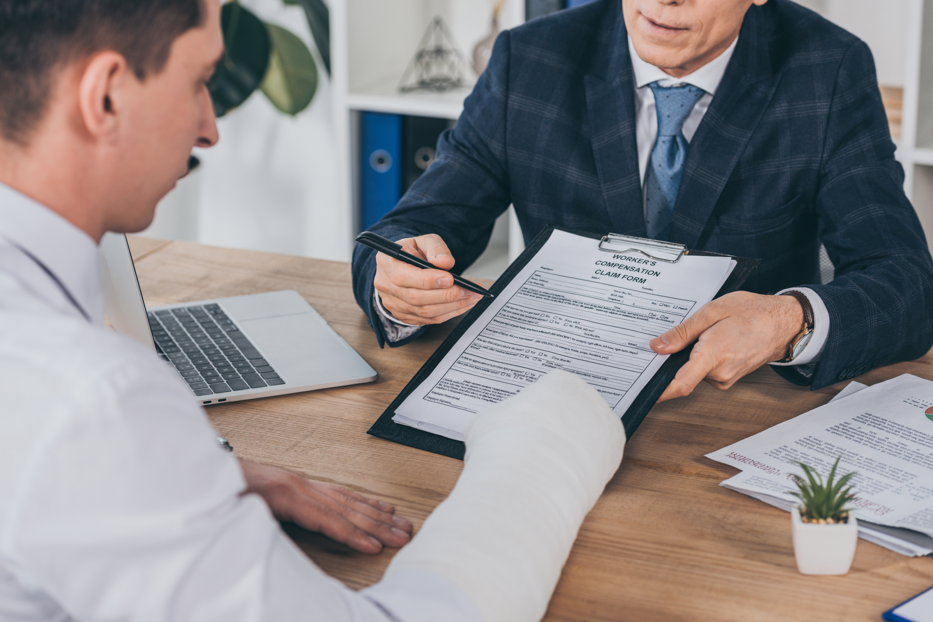Two business professionals in suits reviewing documents, discussing strategy.