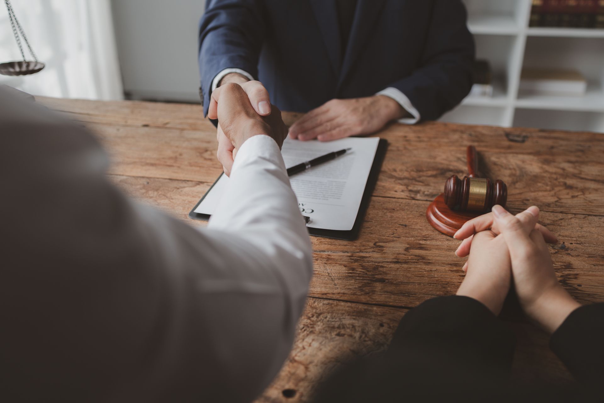 Two business professionals in suits reviewing documents, discussing strategy.