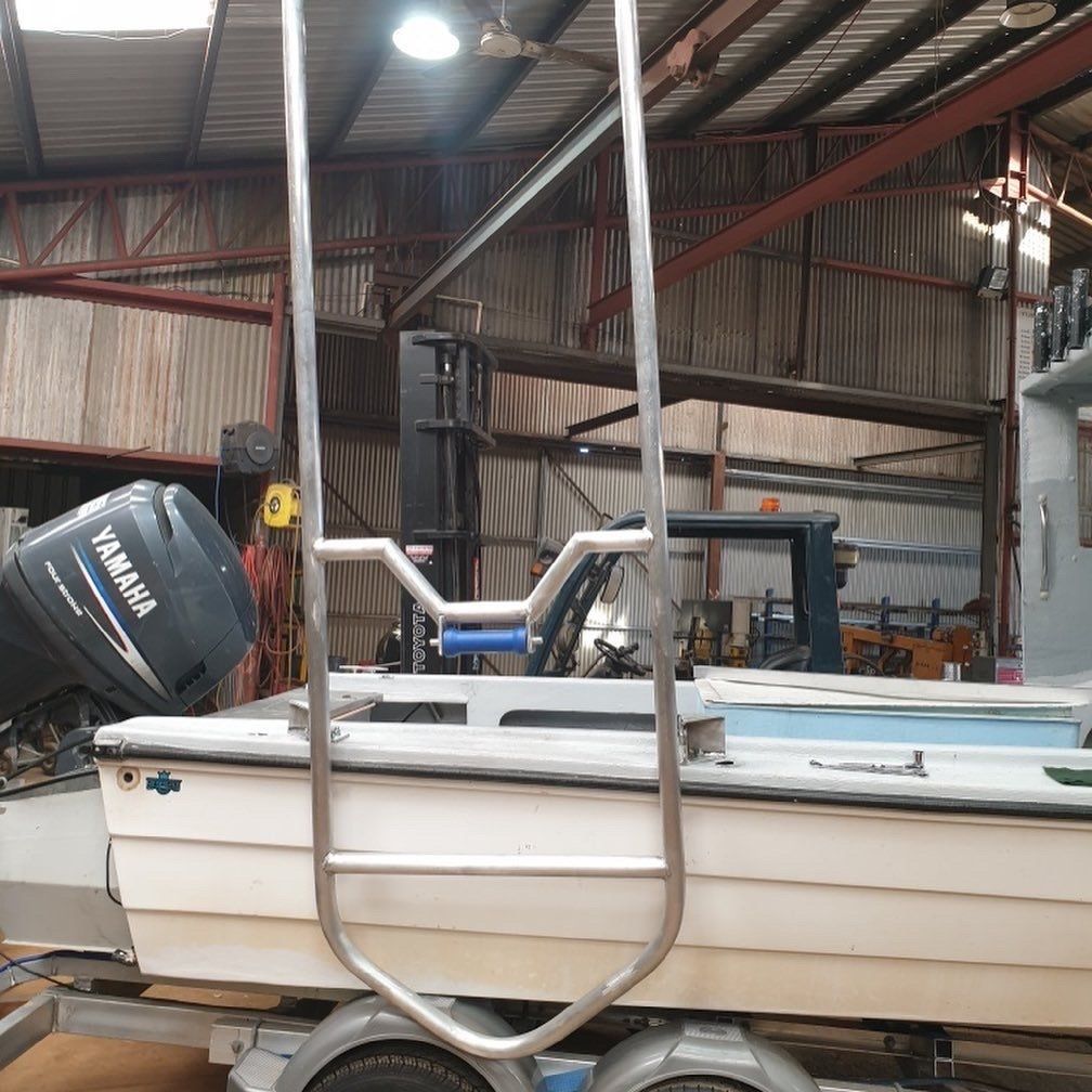 A yamaha boat is on a trailer in a garage