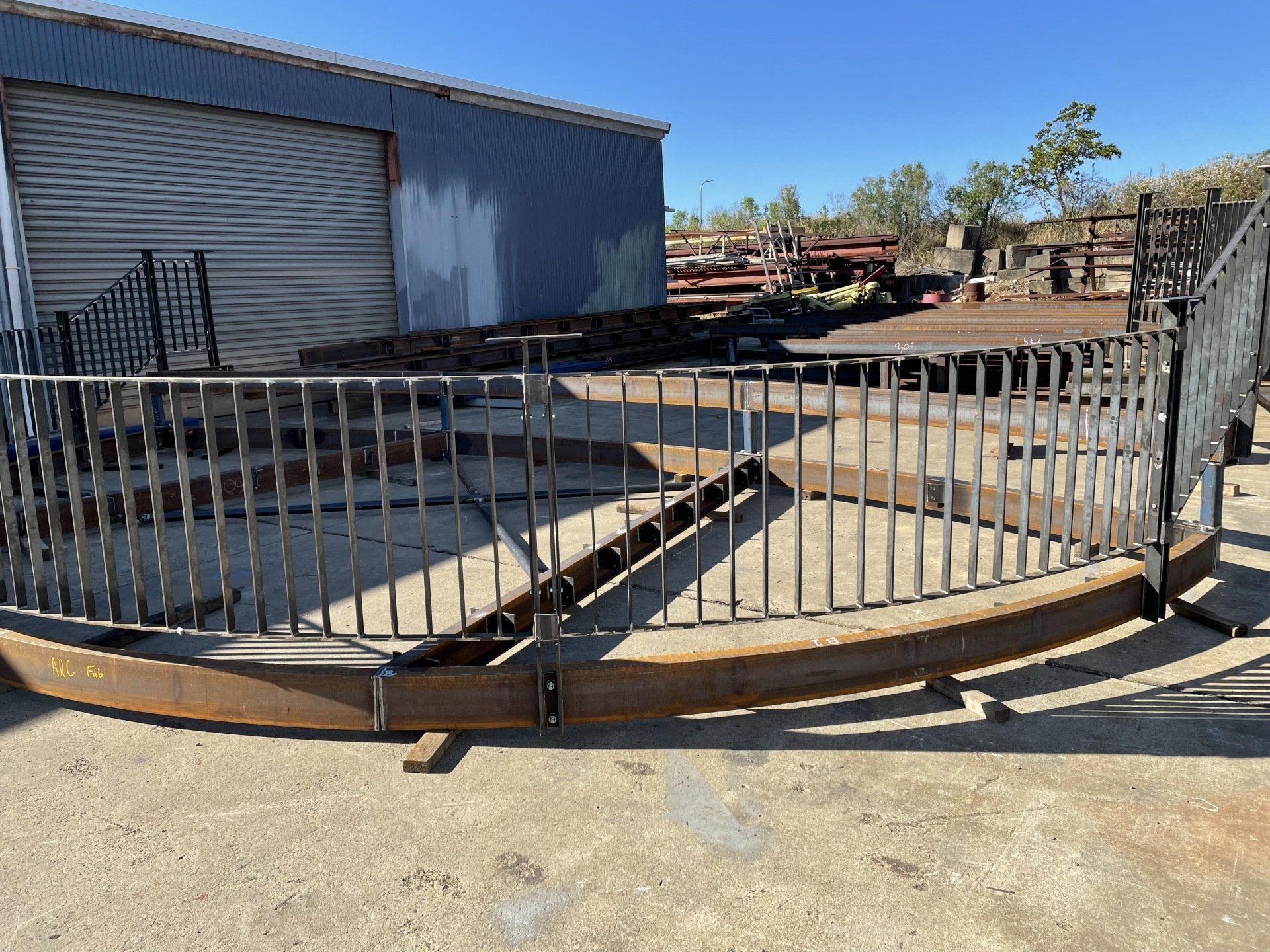 A large metal fence is sitting in front of a building