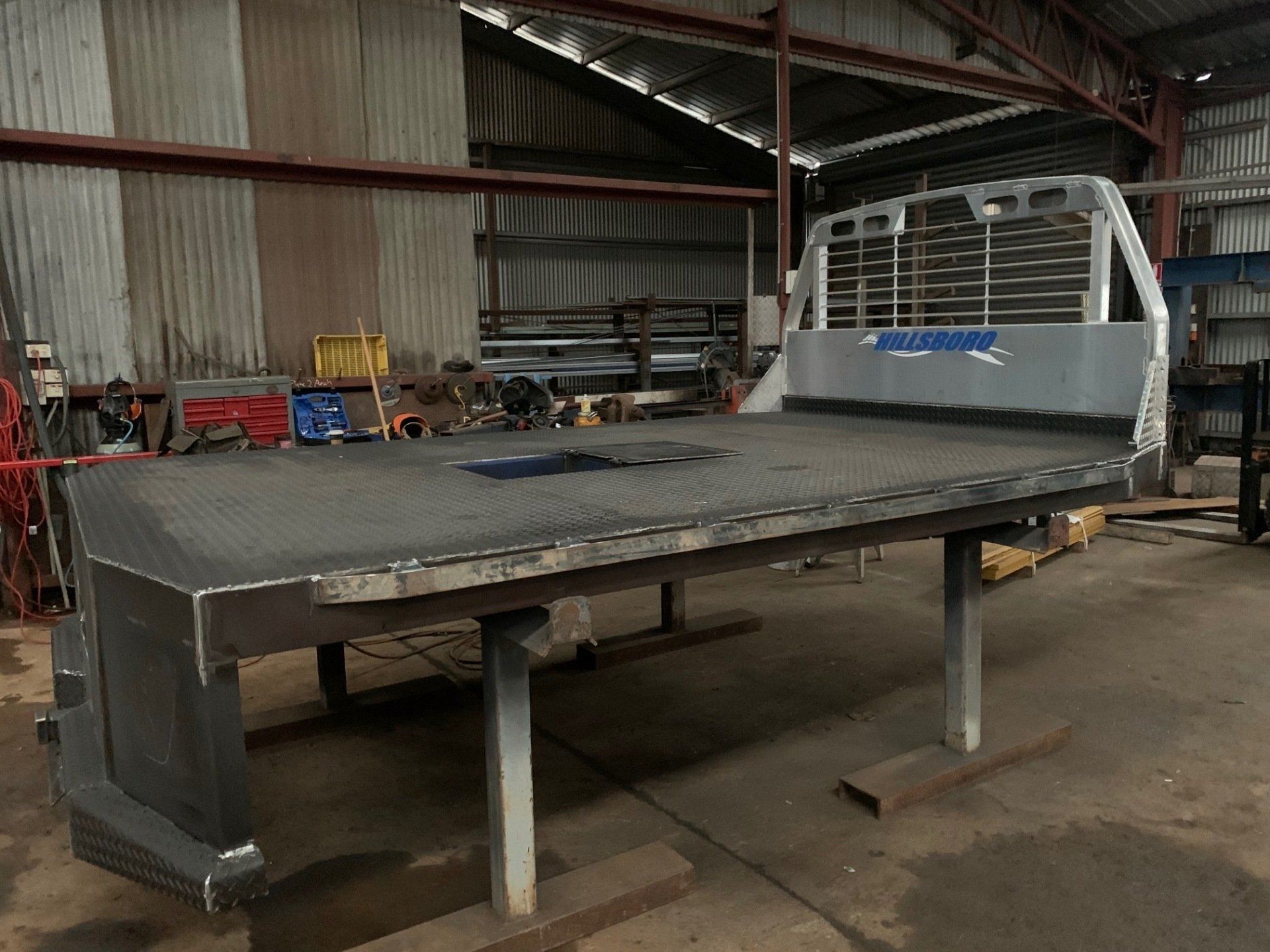 A truck bed is being built in a warehouse.