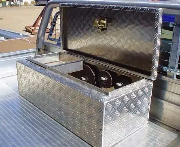 A stainless steel box is sitting in the back of a truck.