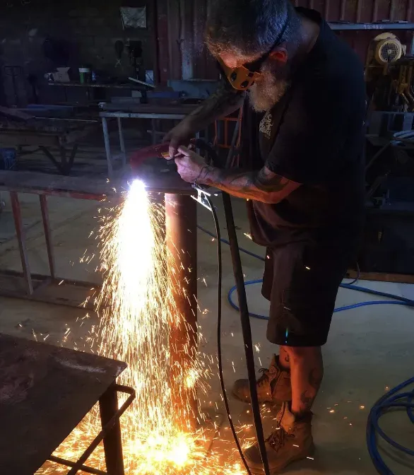 Welder Uses Torch to Connect Steel — Arc Attack Fabrication in Woolgoolga, NSW