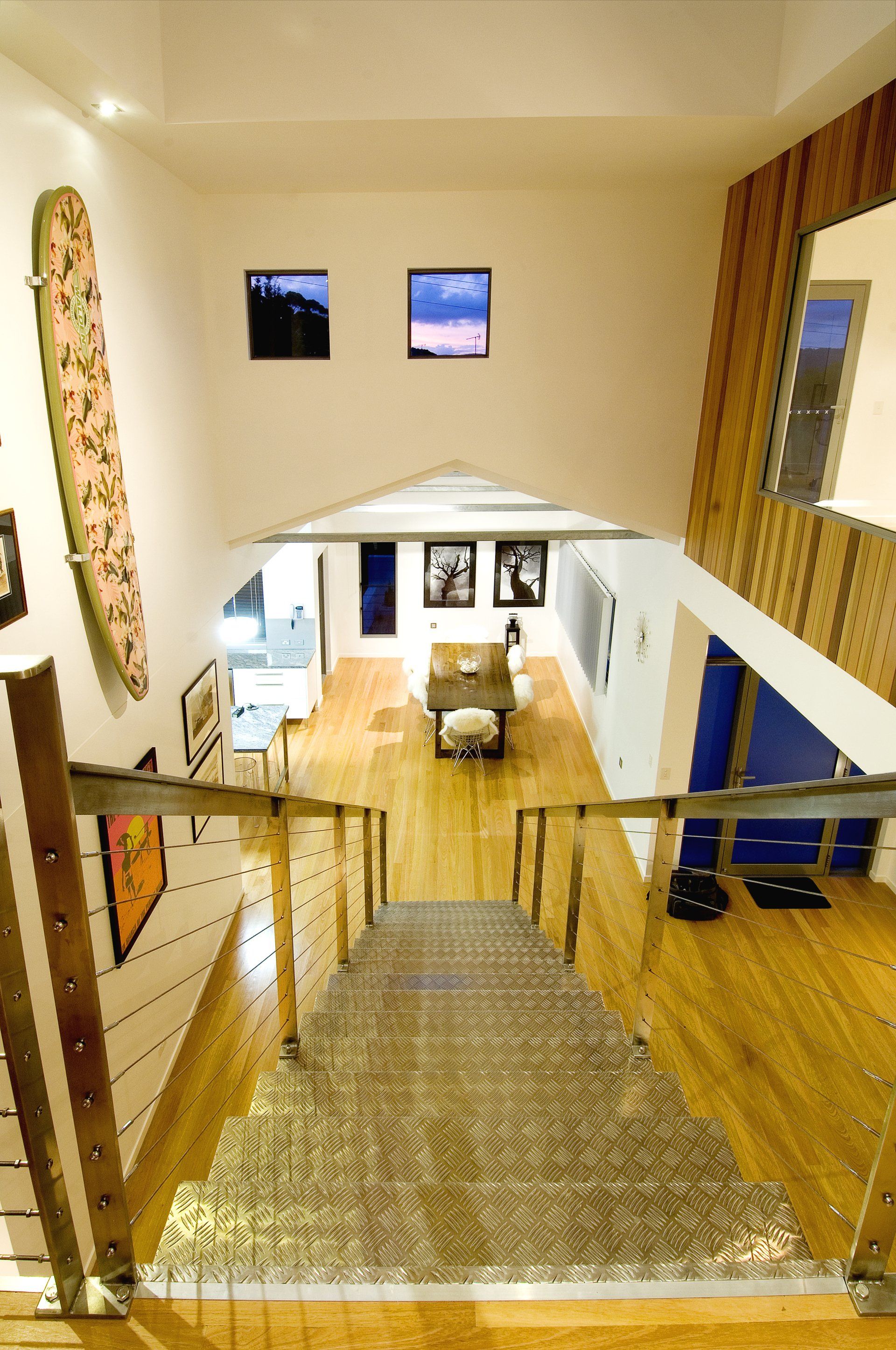 An aerial view of a house with stairs and a surfboard on the wall