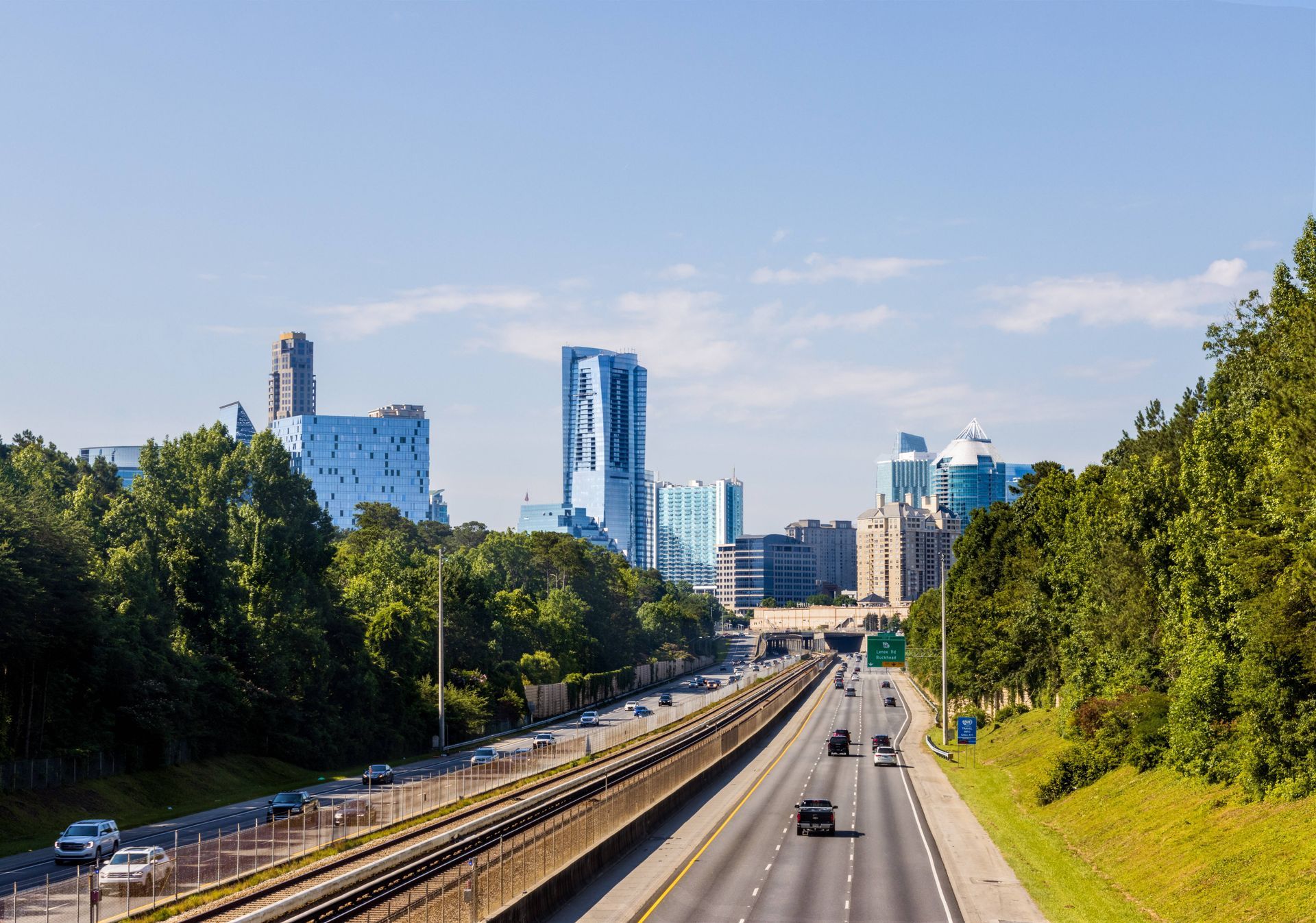 Image with the city skyline, and a road headed toward it and away toward Buckhead, GA