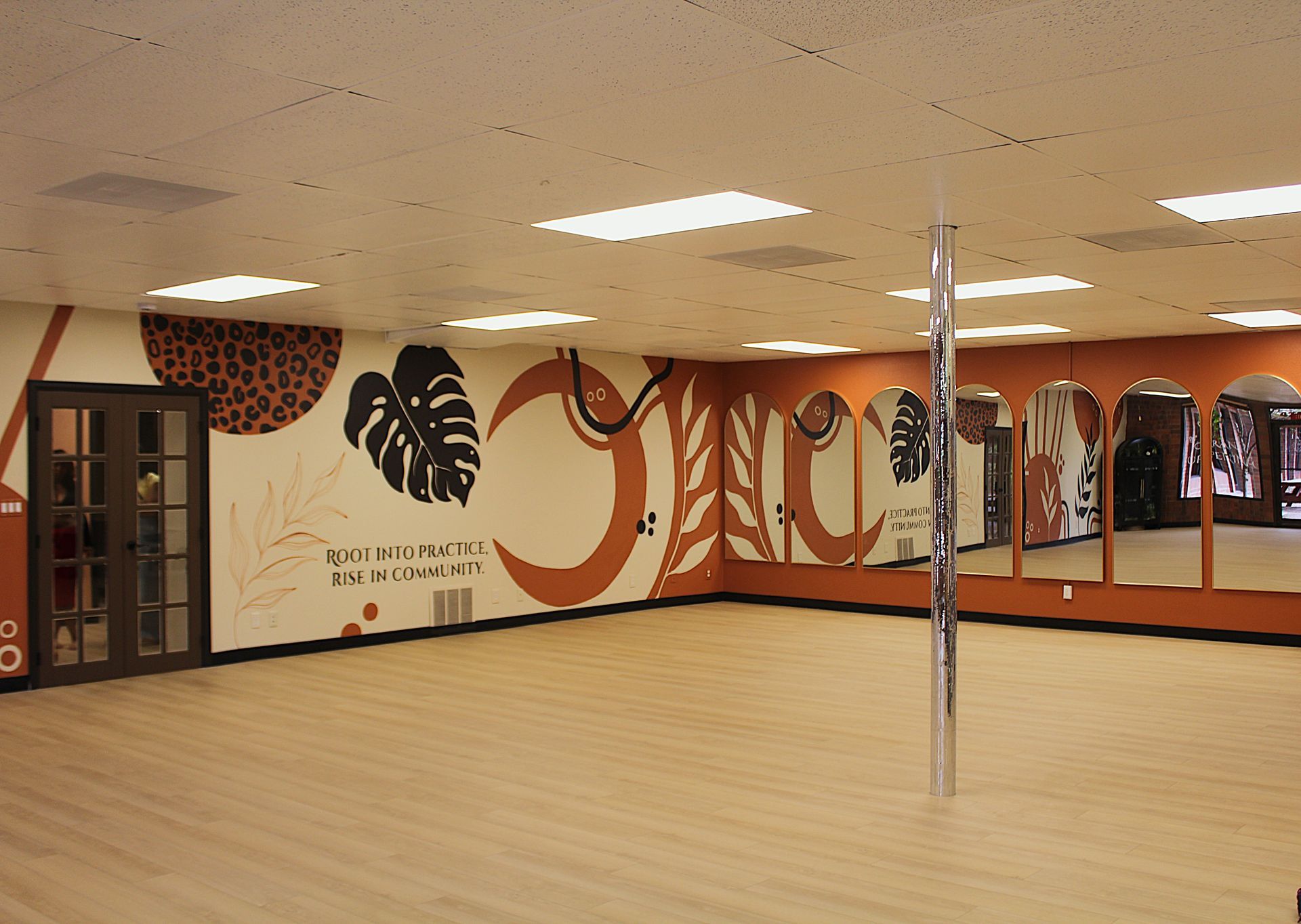 arched mirror wall in Ixora studio for movement and community
