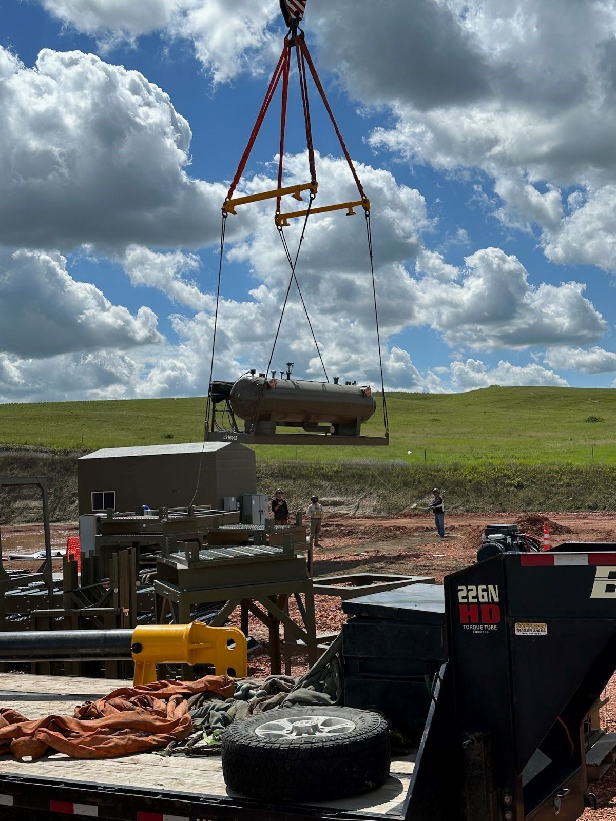 A large object is being lifted by a crane on top of a trailer.