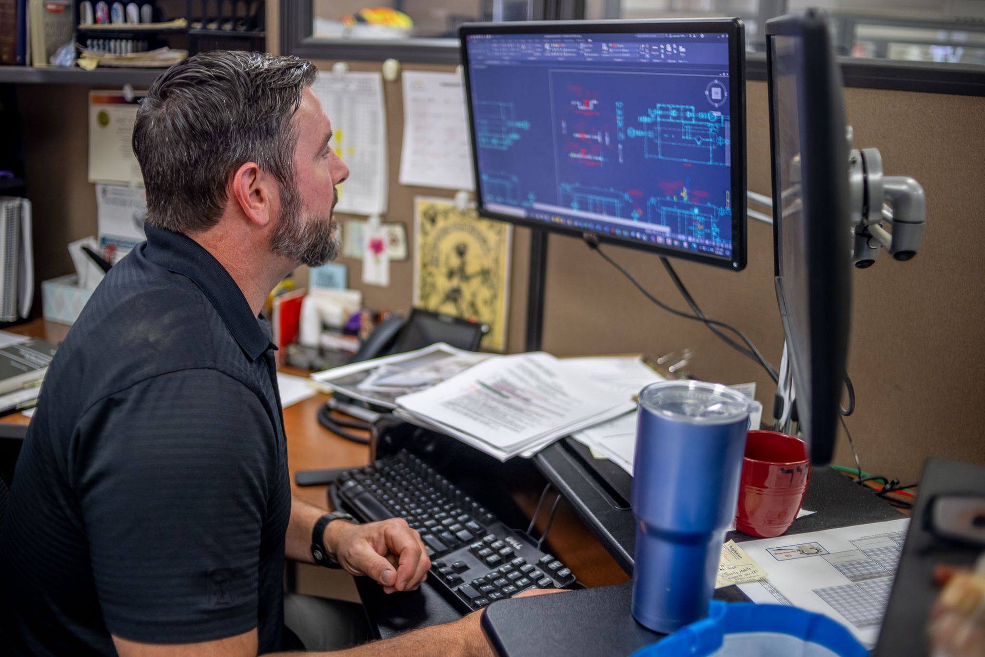 a Pesco employee sits at a desk looking at a computer screen