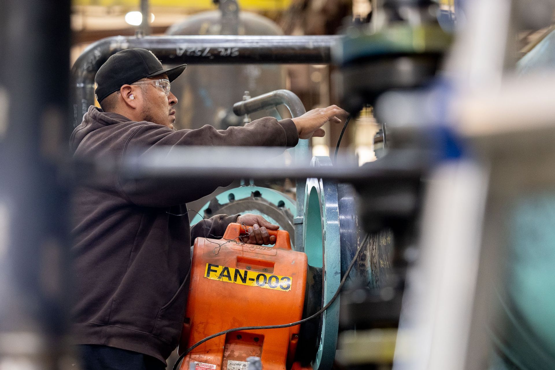 a PESCO employee is working on a fan-doo machine