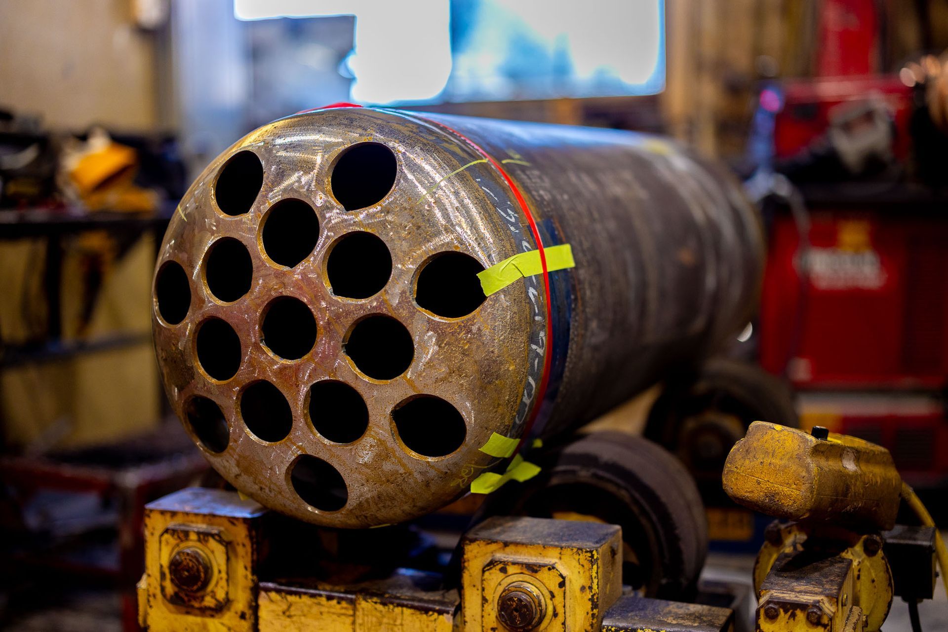 a bunch of pipes in a factory with one that says ' stainless steel ' on it
