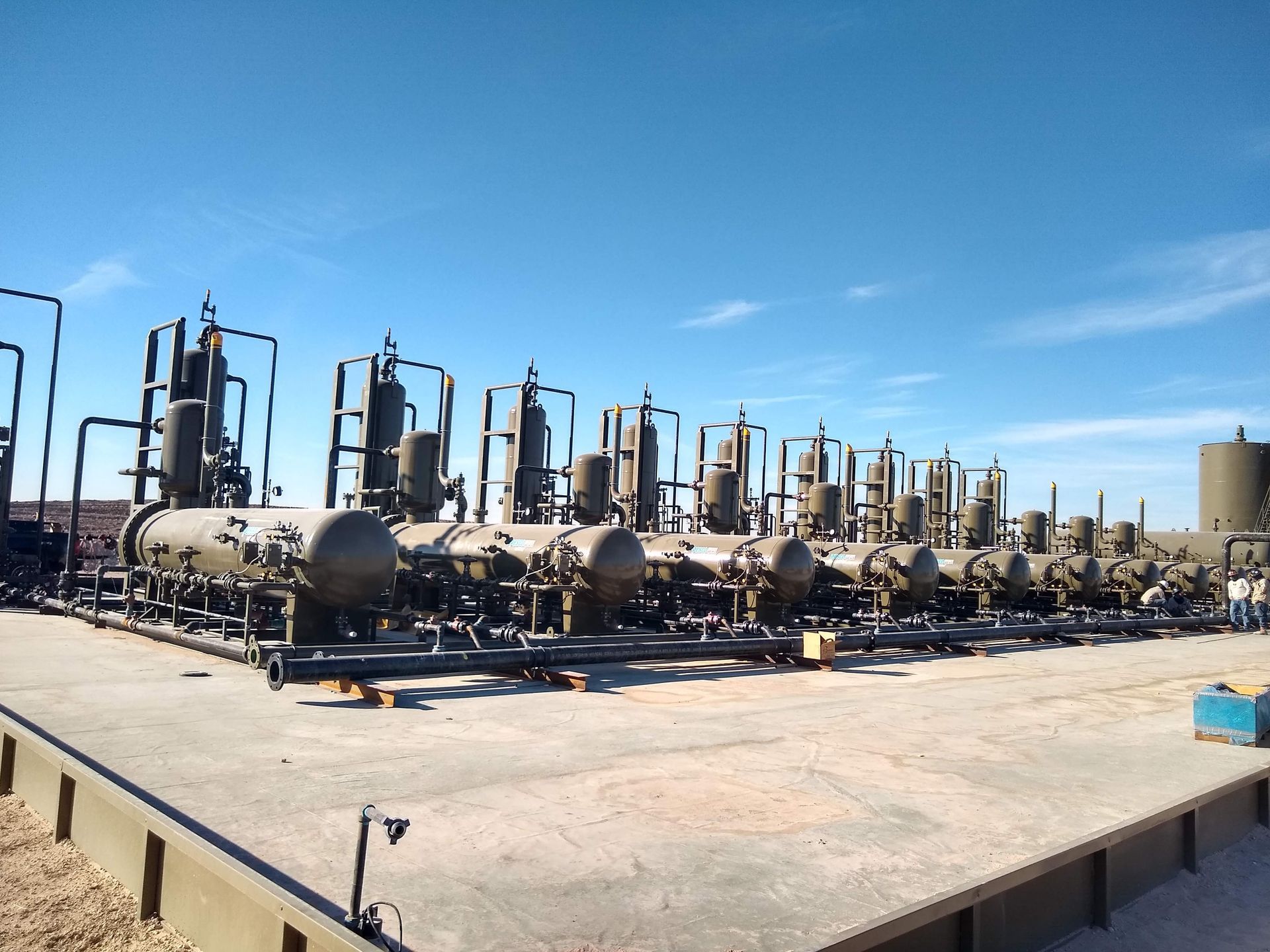 A row of tanks are lined up in a parking lot