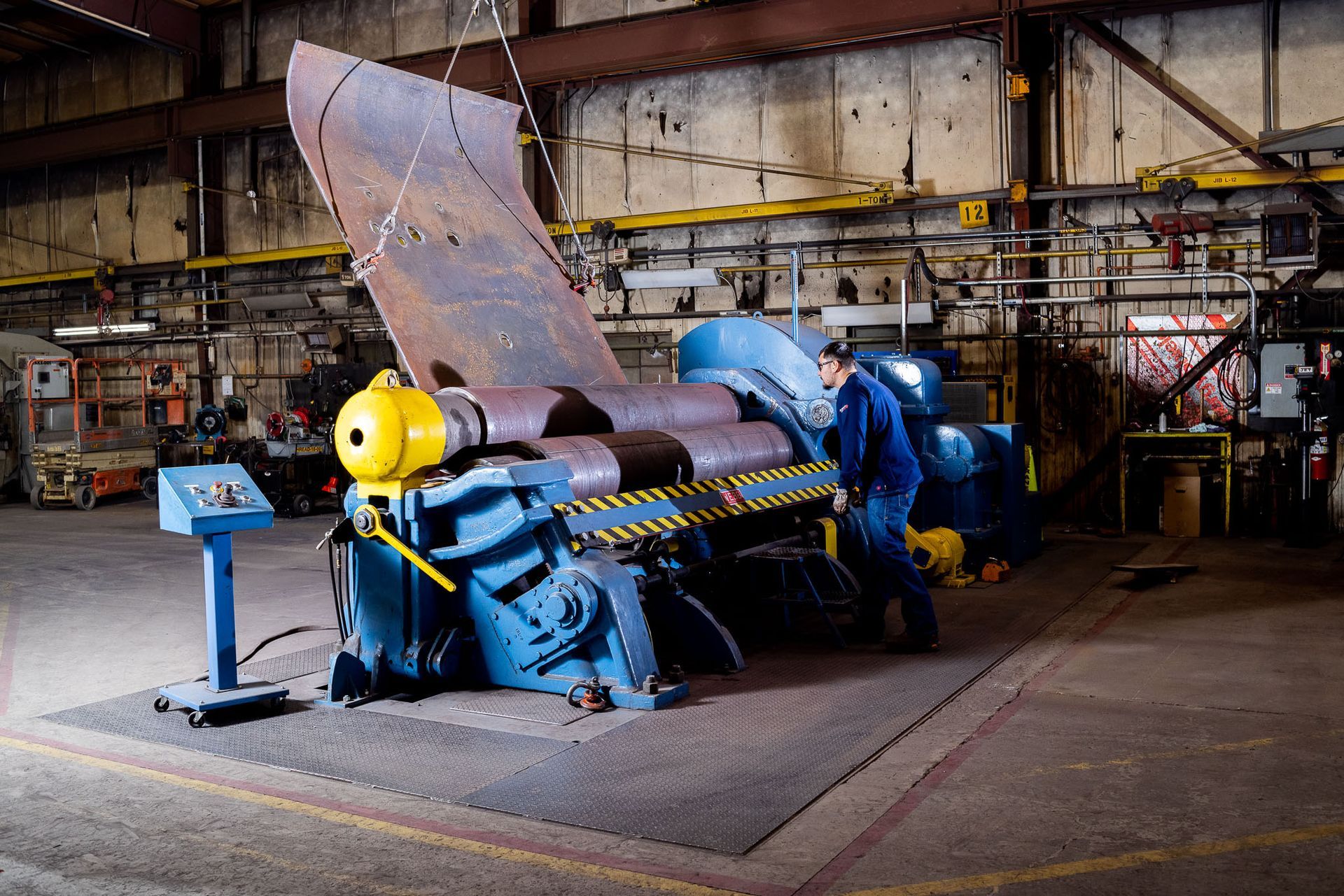 a bunch of pipes in a factory with one that says ' stainless steel ' on it
