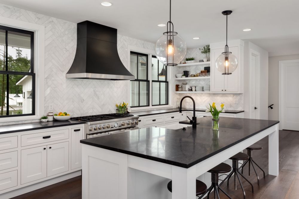 A Kitchen With White Cabinets and a Large Island — TM Built Construction In Cessnock, NSW