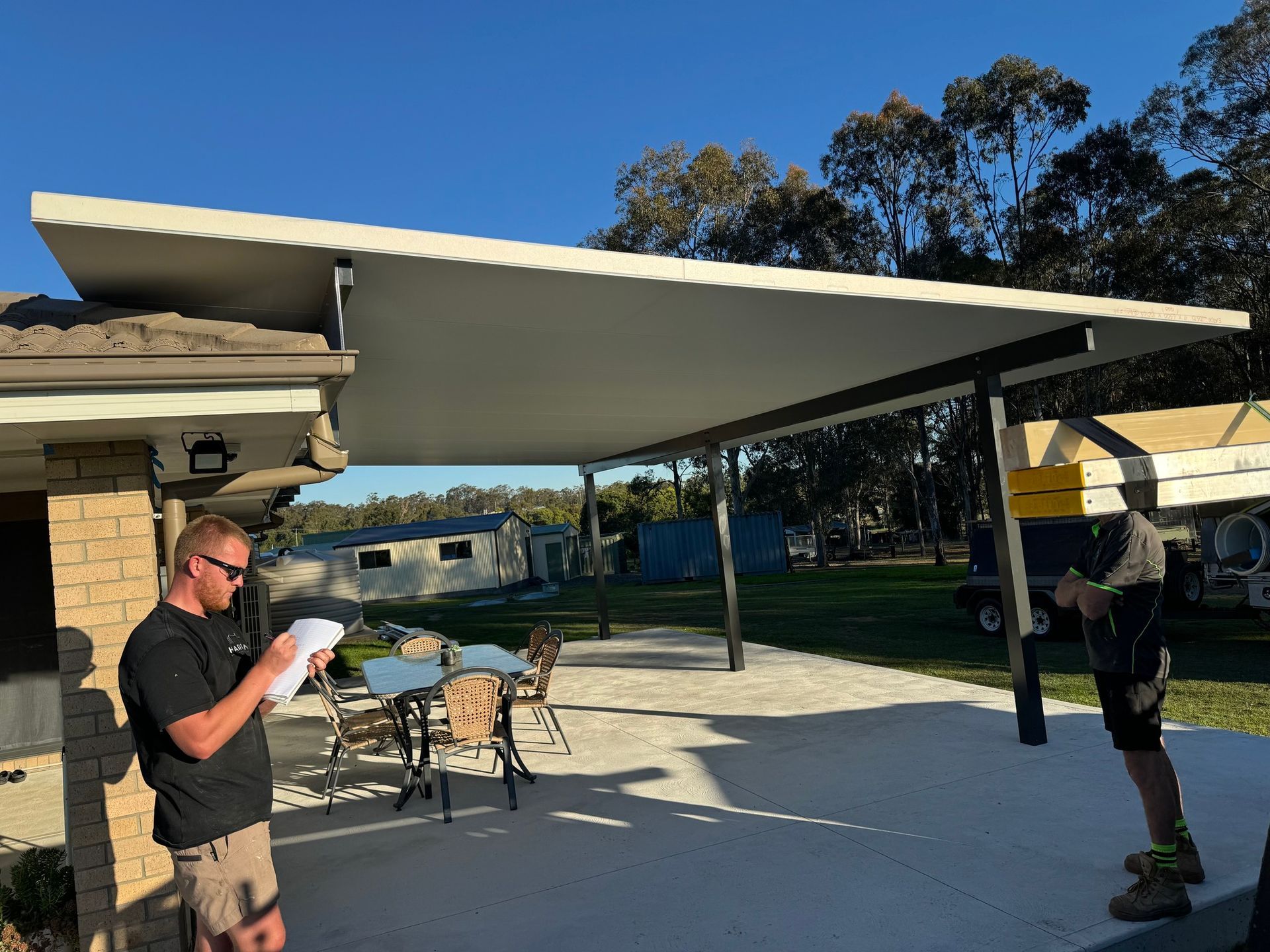 A Man is Working on a Wooden Deck — TM Built Construction In Lochinvar, NSW