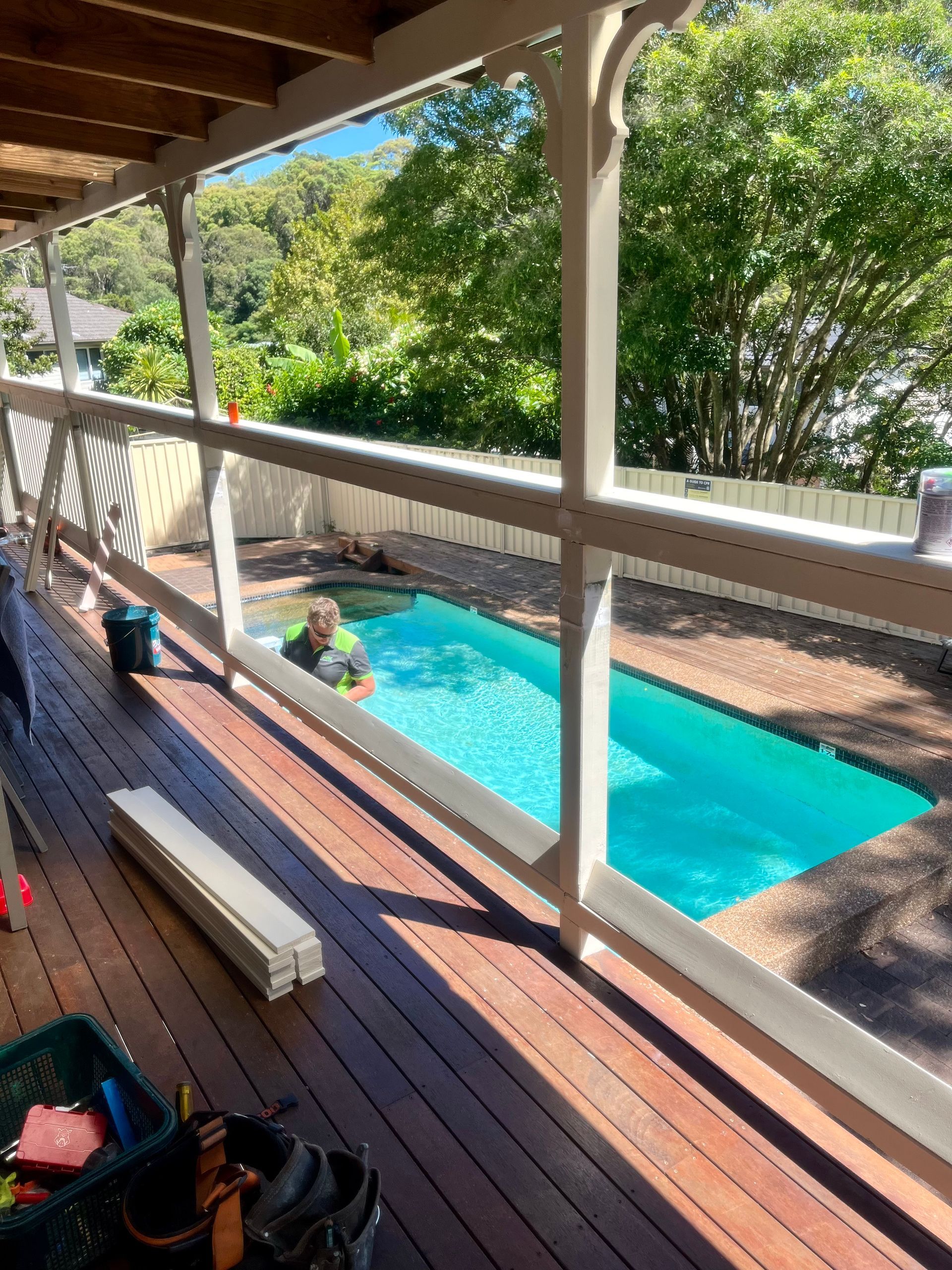 A Person is Fixing a Shower Head With a Screwdriver — TM Built Construction In Lochinvar, NSW