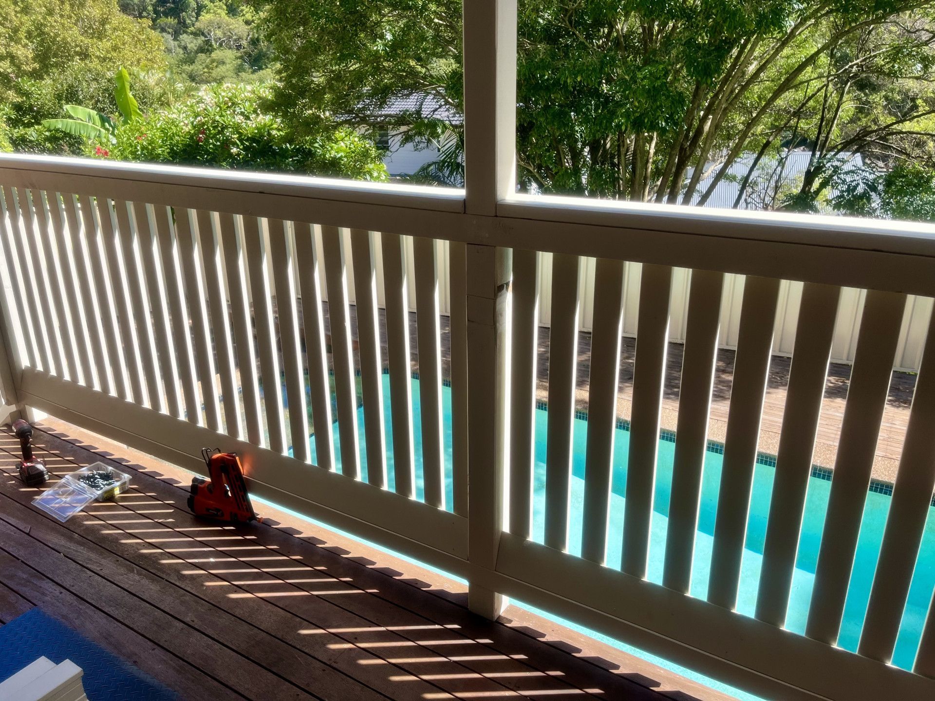 A Pergola With a Couch and Chairs Underneath It in a Backyard — TM Built Construction In Cessnock, NSW