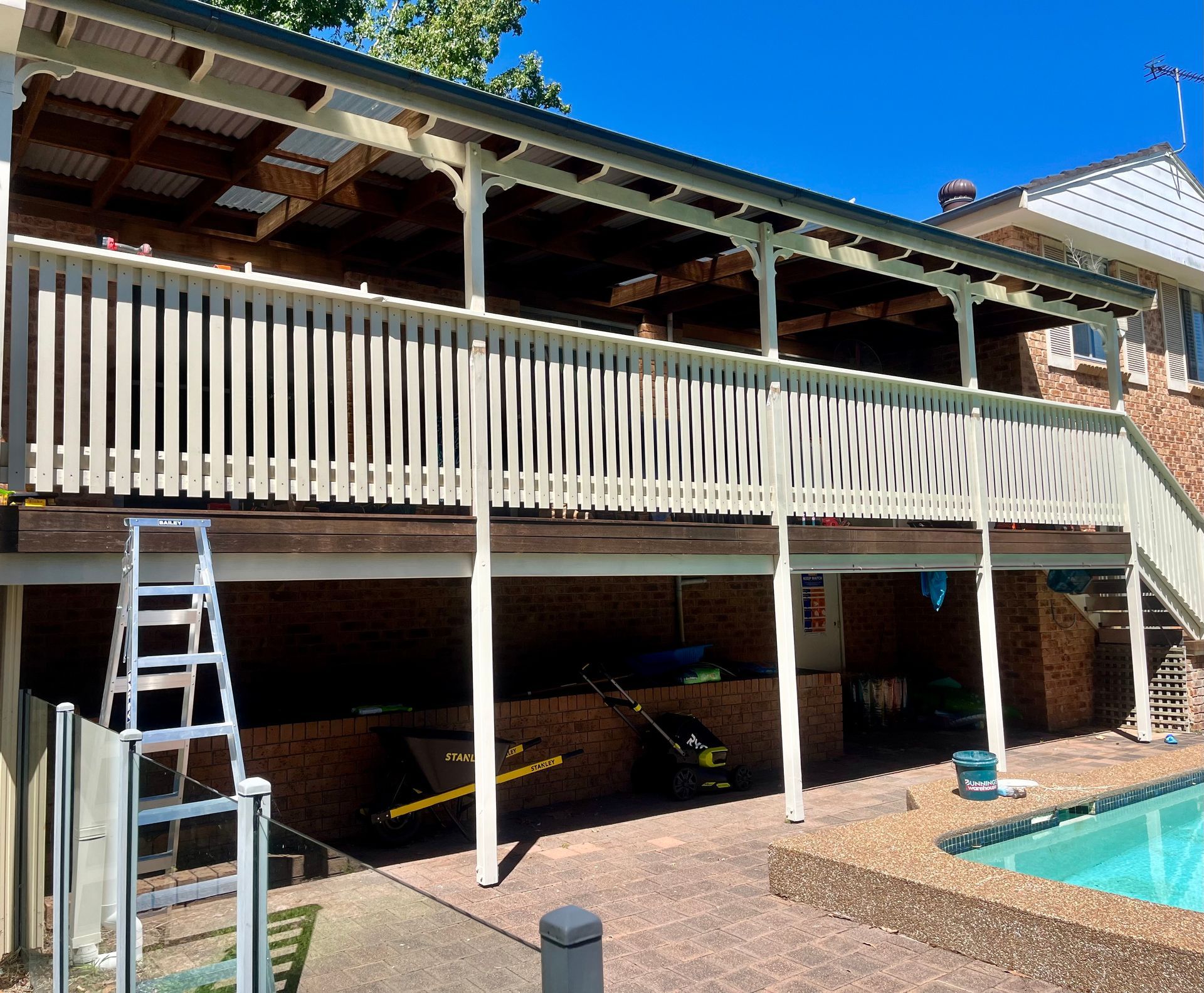 A house with a large deck and a pool in the backyard — TM Built Construction In Lochinvar, NSW