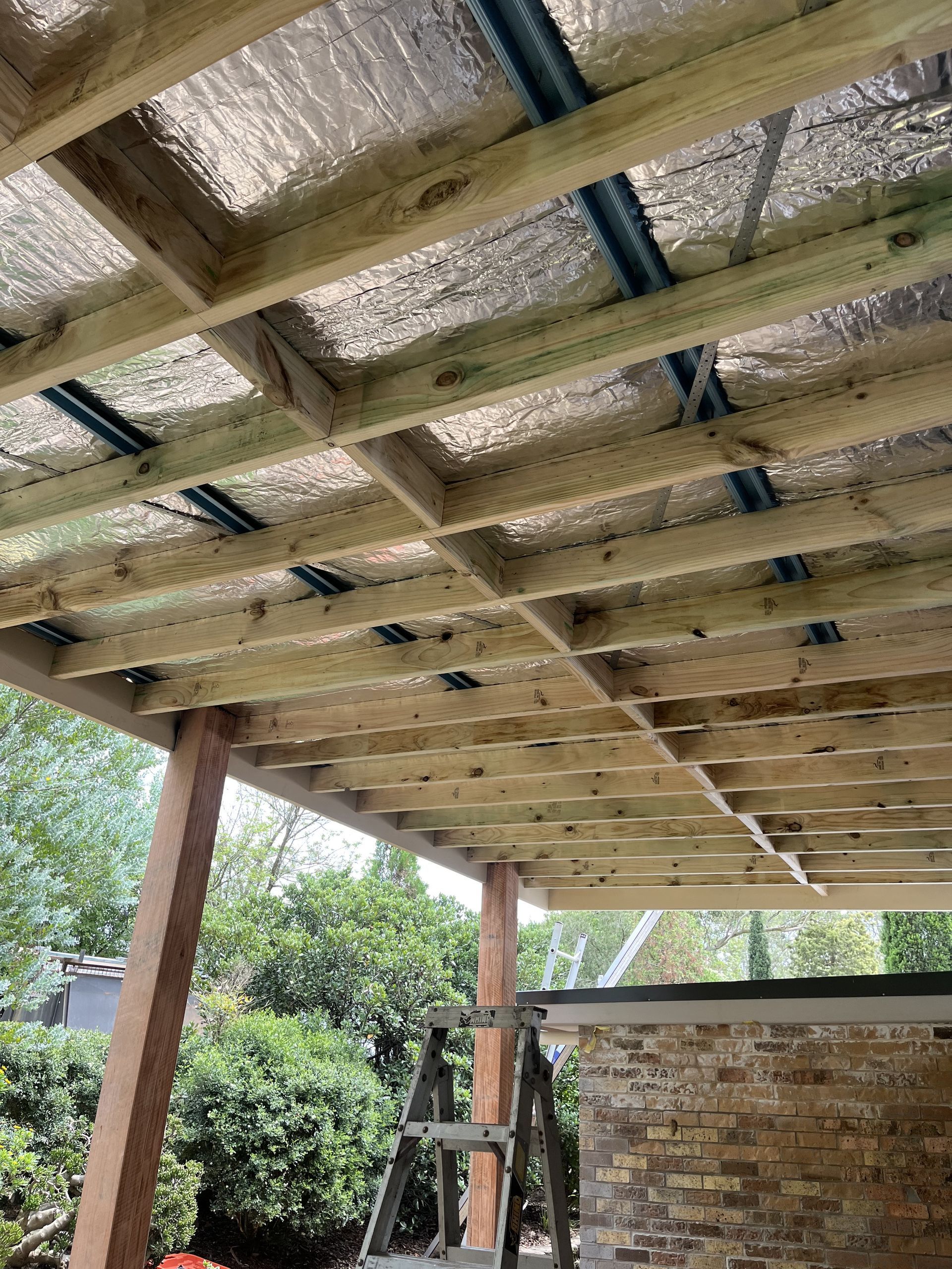 There is a Swimming Pool in the Backyard With a Pergola — TM Built Construction In Cessnock, NSW