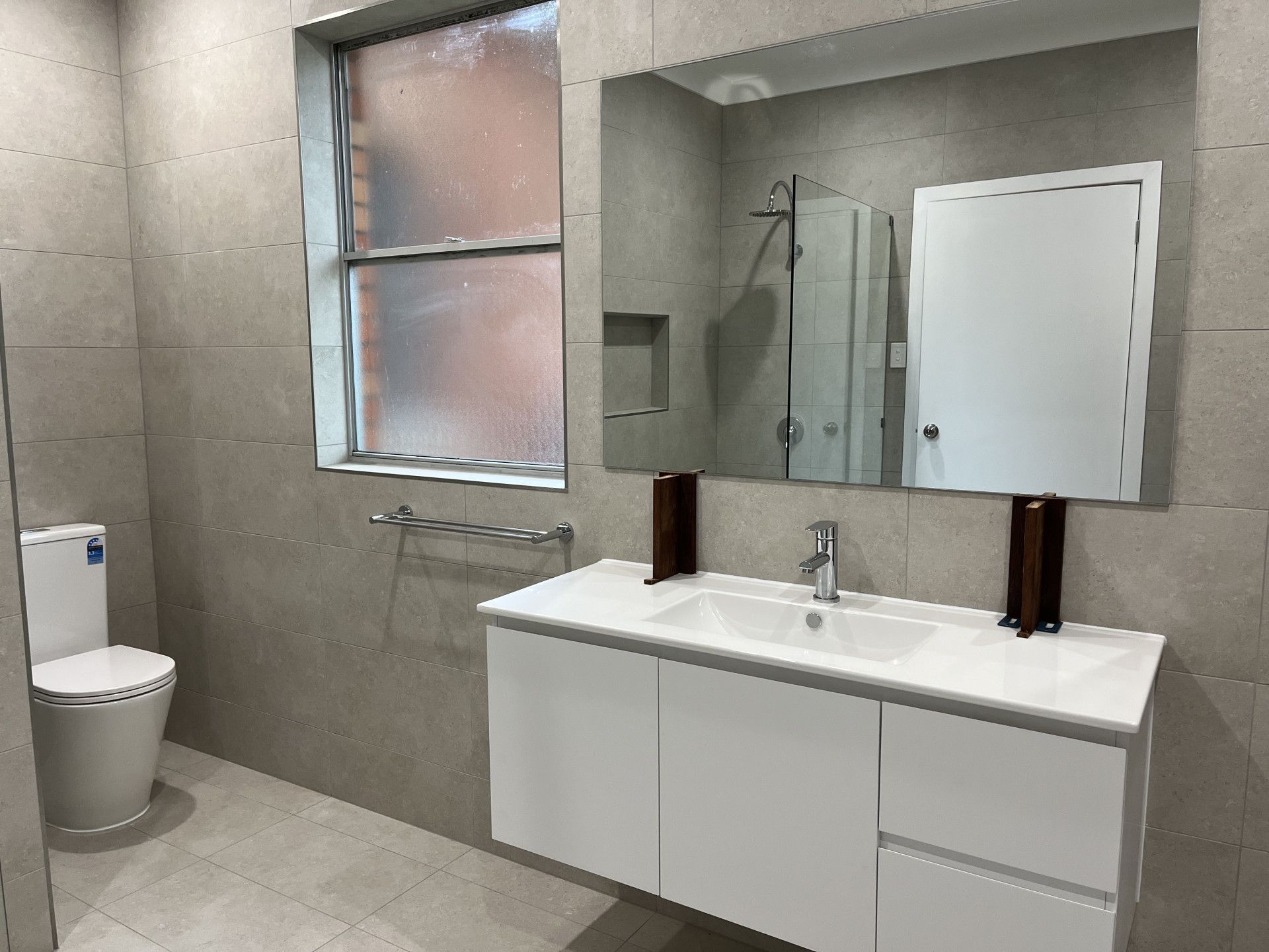A Bathroom With Two Sinks and a Walk in Closet — TM Built Construction In Singleton, NSW