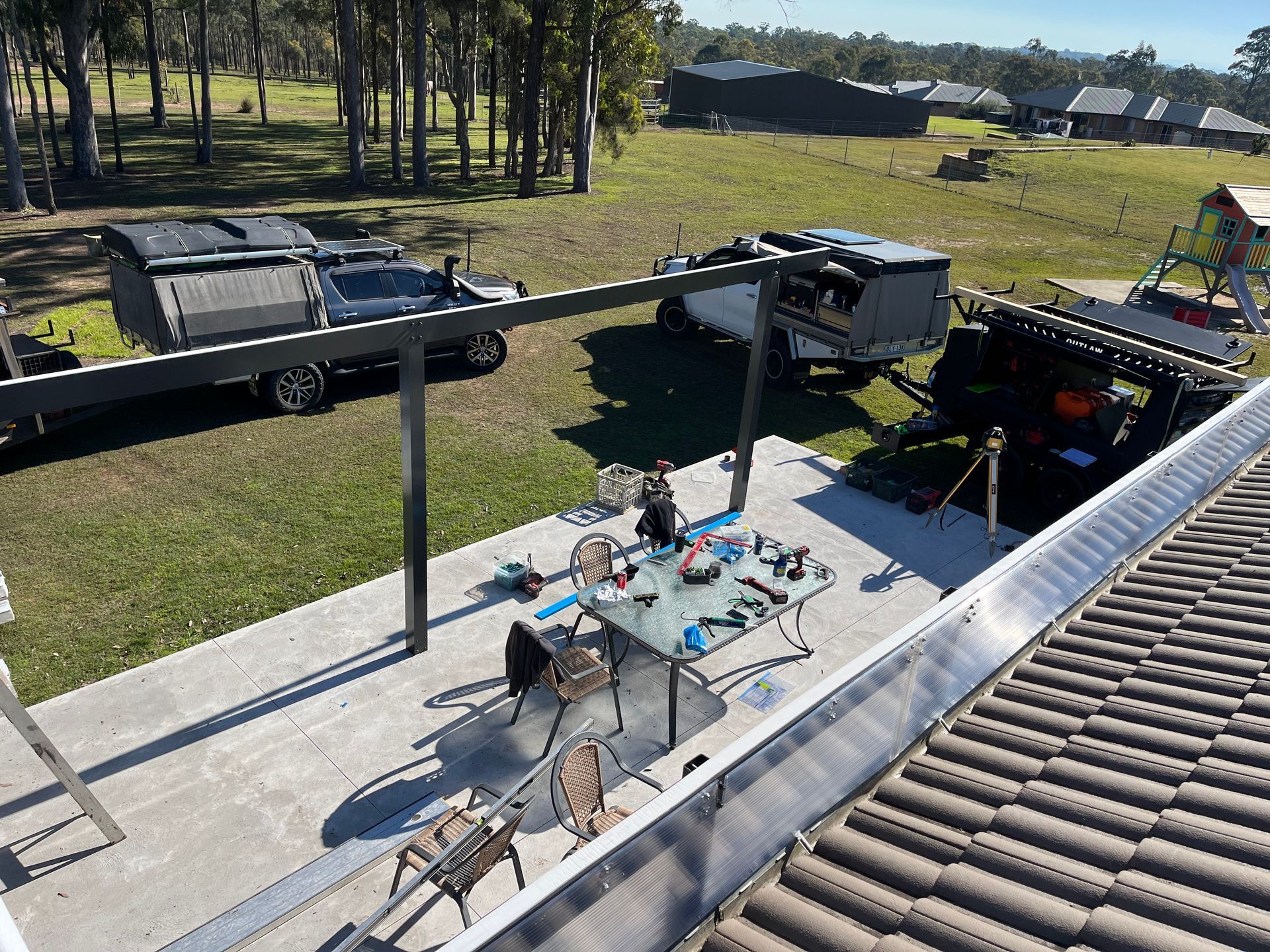 There is a table and chairs on the roof of a house — TM Built Construction In Lochinvar, NSW