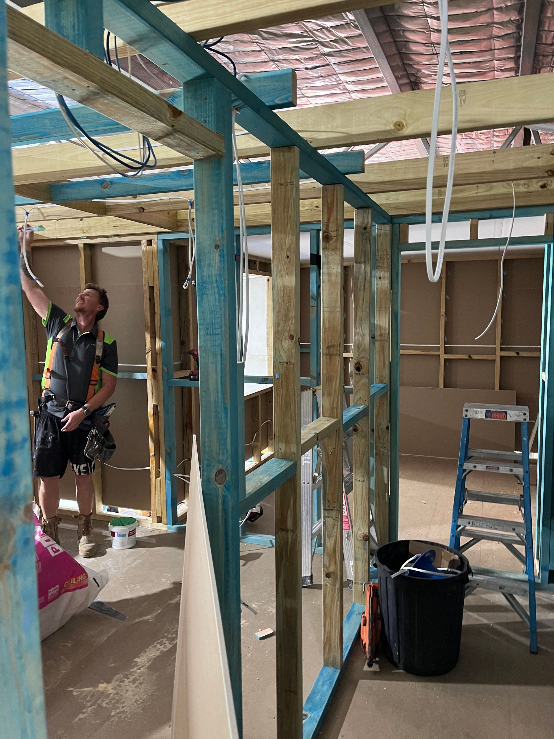 A man is working on the ceiling of a building under construction — TM Built Construction In Lochinvar, NSW