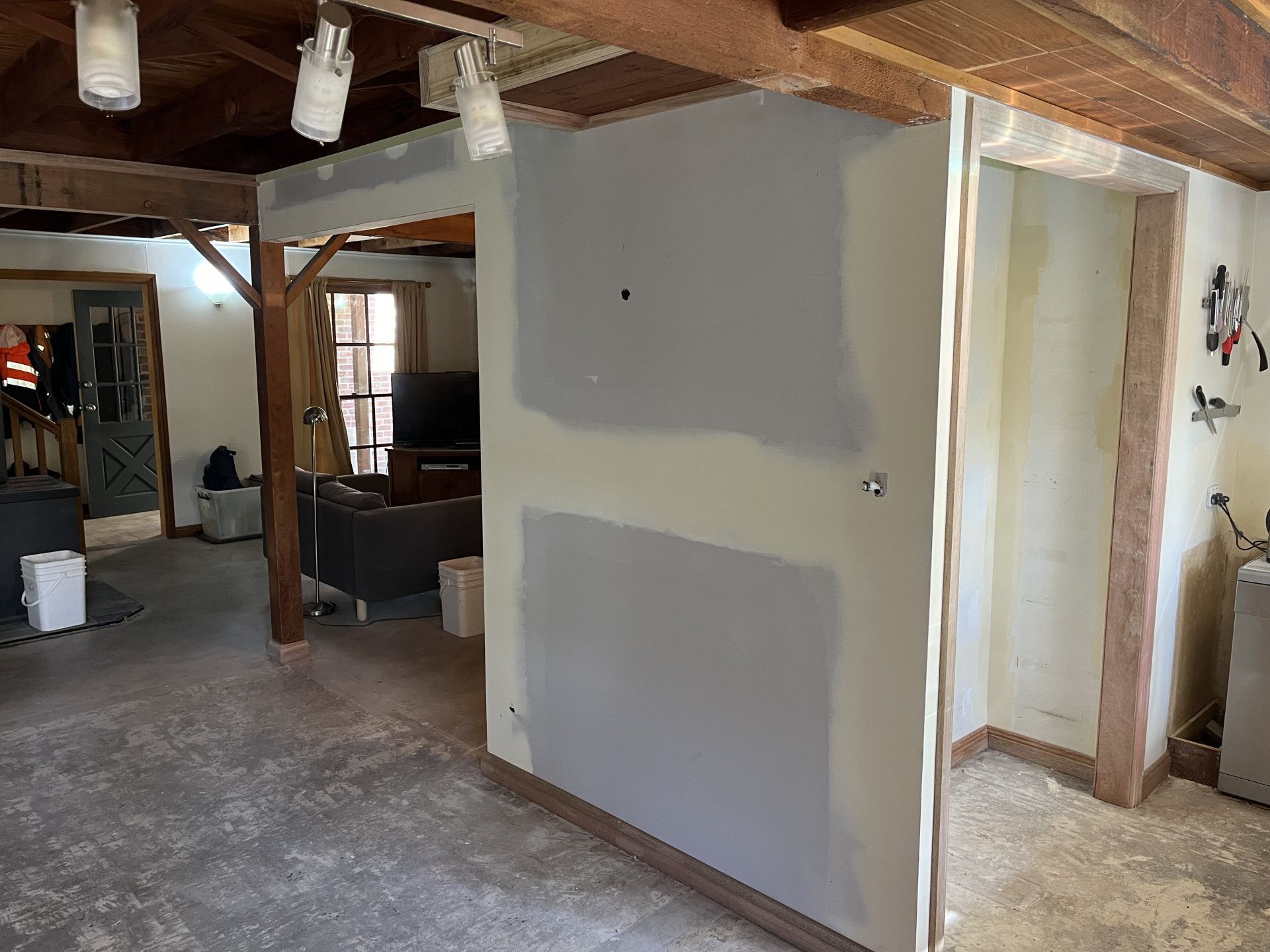a Living Room With a Couch and Stairs — TM Built Construction In Cessnock, NSW