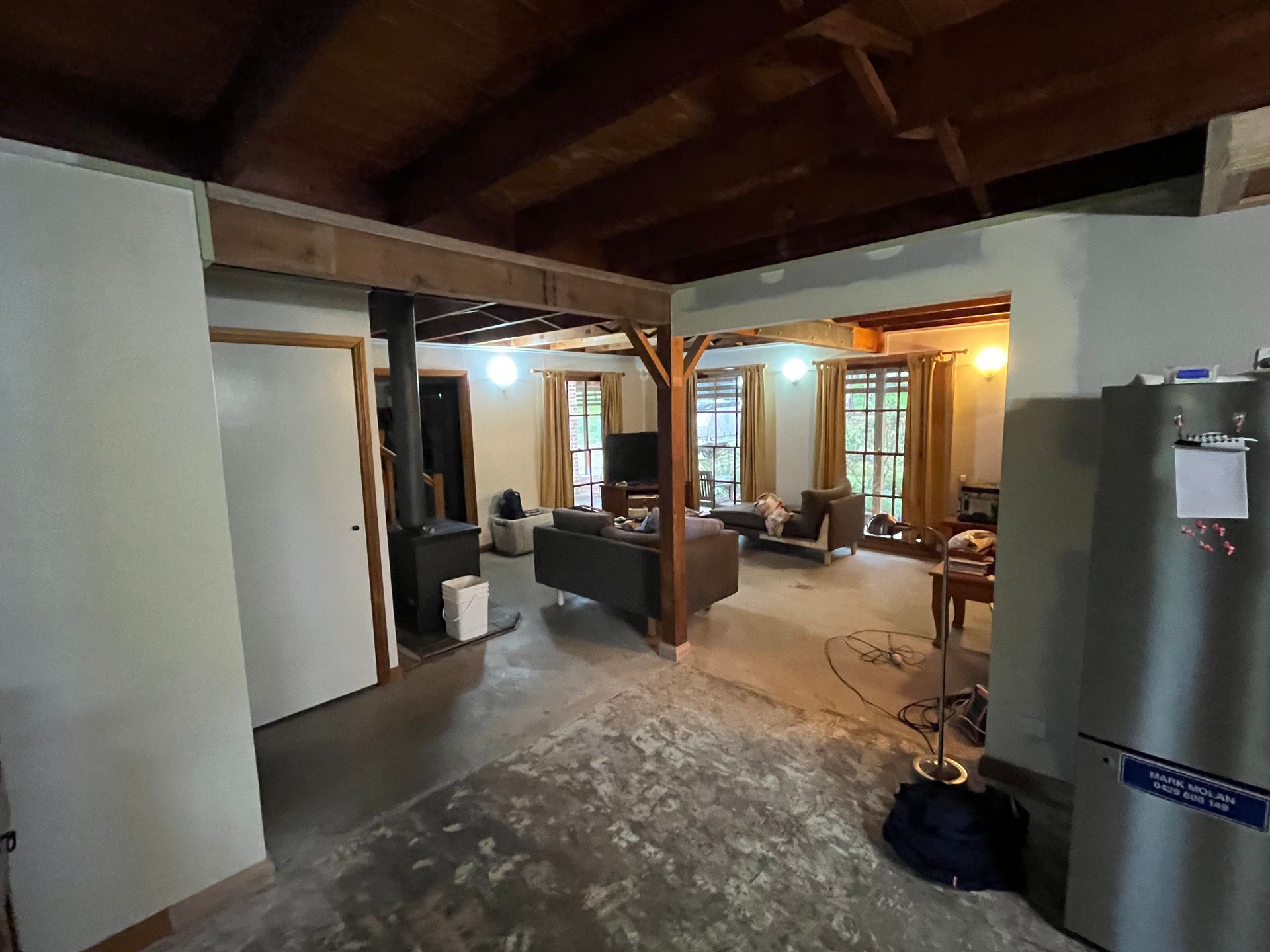 A living room in a house with a refrigerator and a stove — TM Built Construction In Lochinvar, NSW